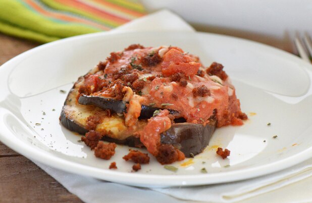 Berenjena al horno cubierta con chorizo, queso y salsa de tomate.
